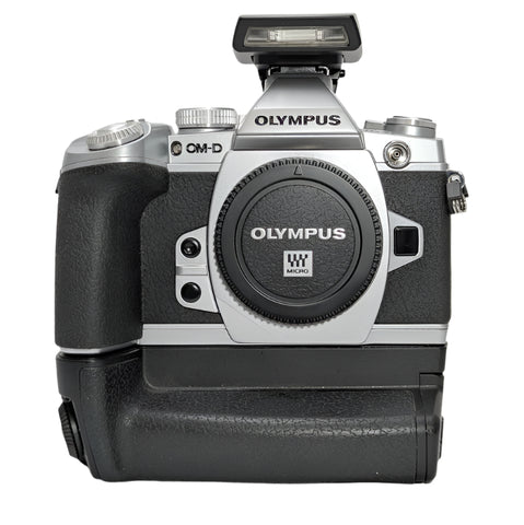 Olympus OM-D E-M1 Silver 16mp Mirrorless Micro-4/3 digital camera Body w/ battery grip and flash